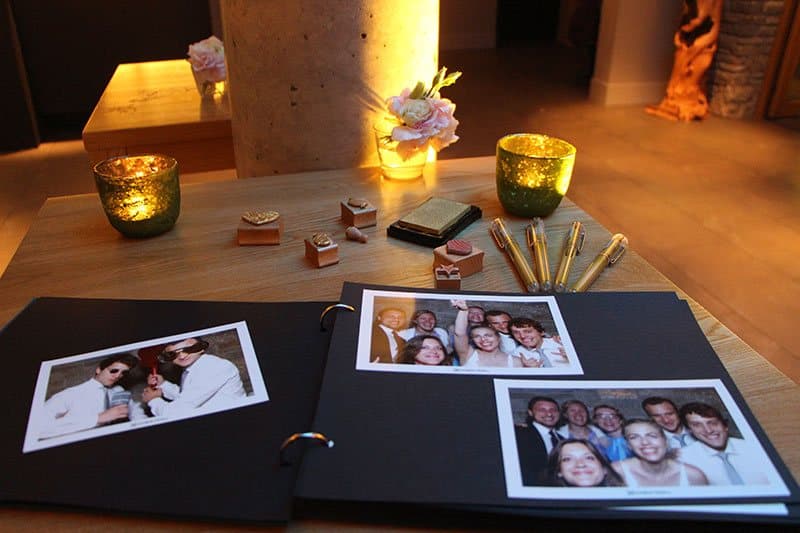 Fotostreifen aus der Fotobox ins Gästebuch geklebt, daneben Windlichter und Stifte